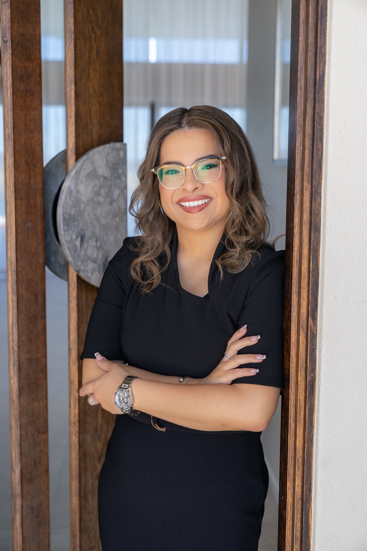 Rebecca Escobar in a black outfit at a property doorway